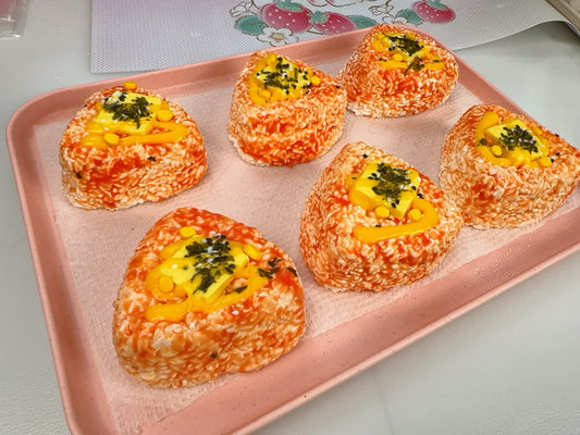 Rice ball with corn and tomato sauce